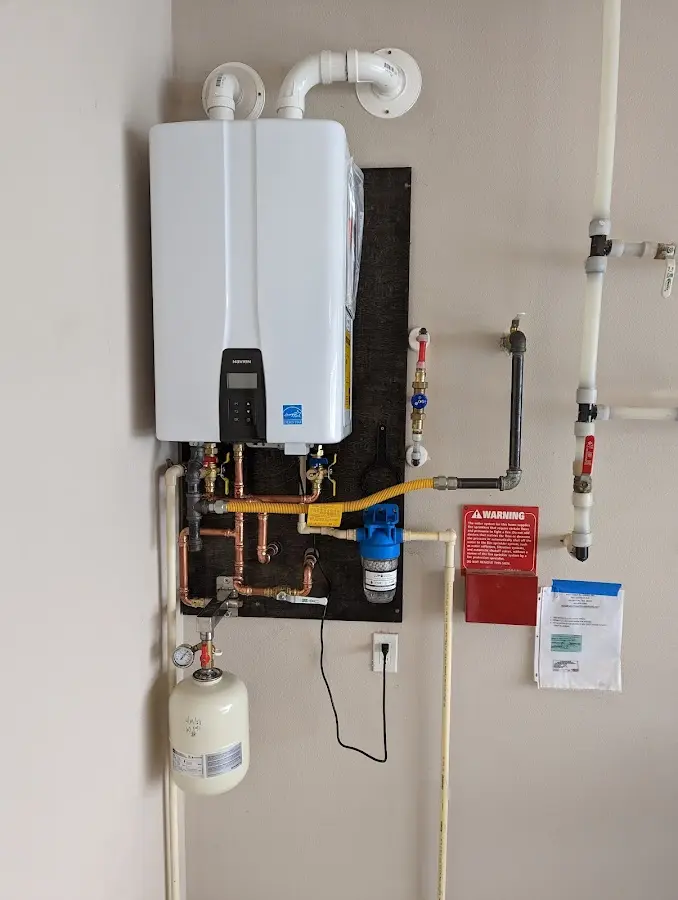 Professional plumber installing copper piping in a Barry home